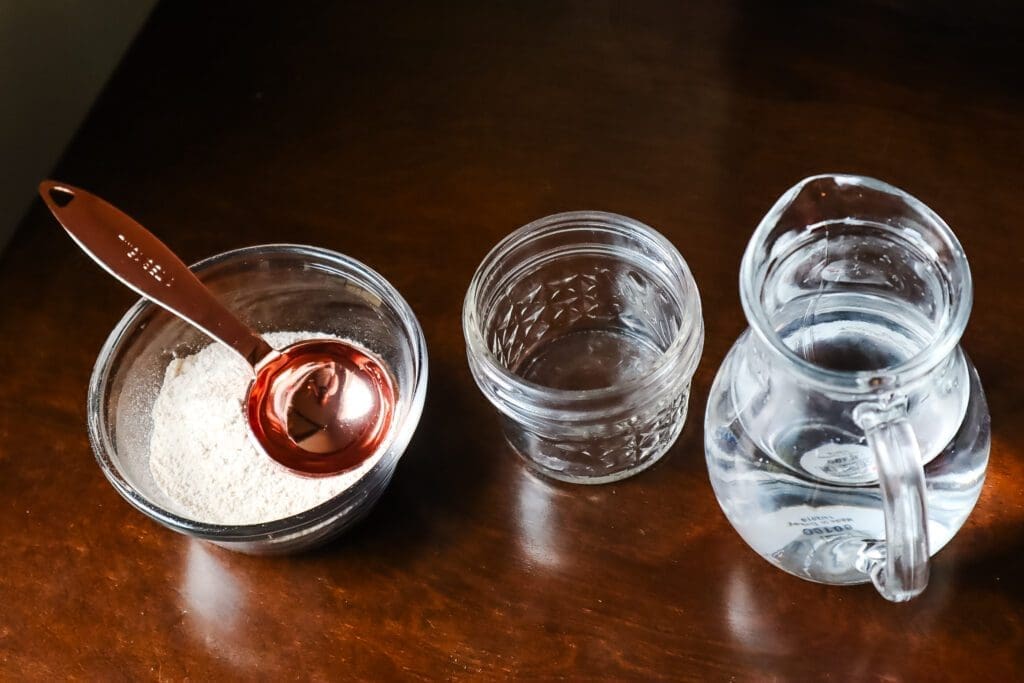 flour in bowl with tablespoon, pitcher, and mason jar