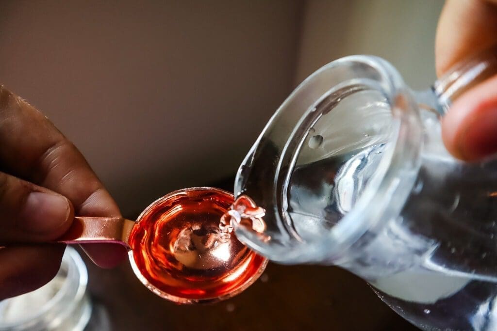 Water poured into tablespoon