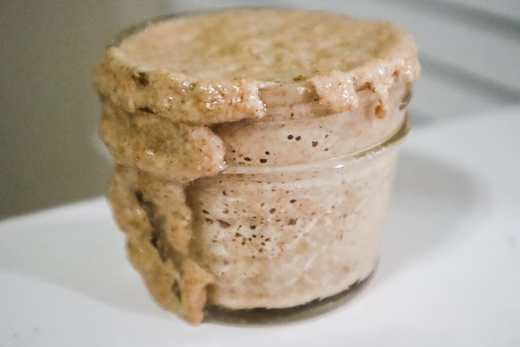 Sourdough starter overflowing mason jar