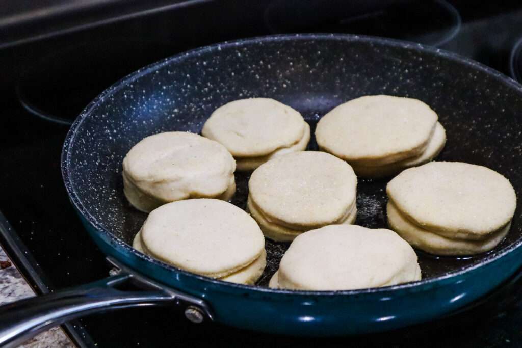 Sourdough English Muffins frying in pan