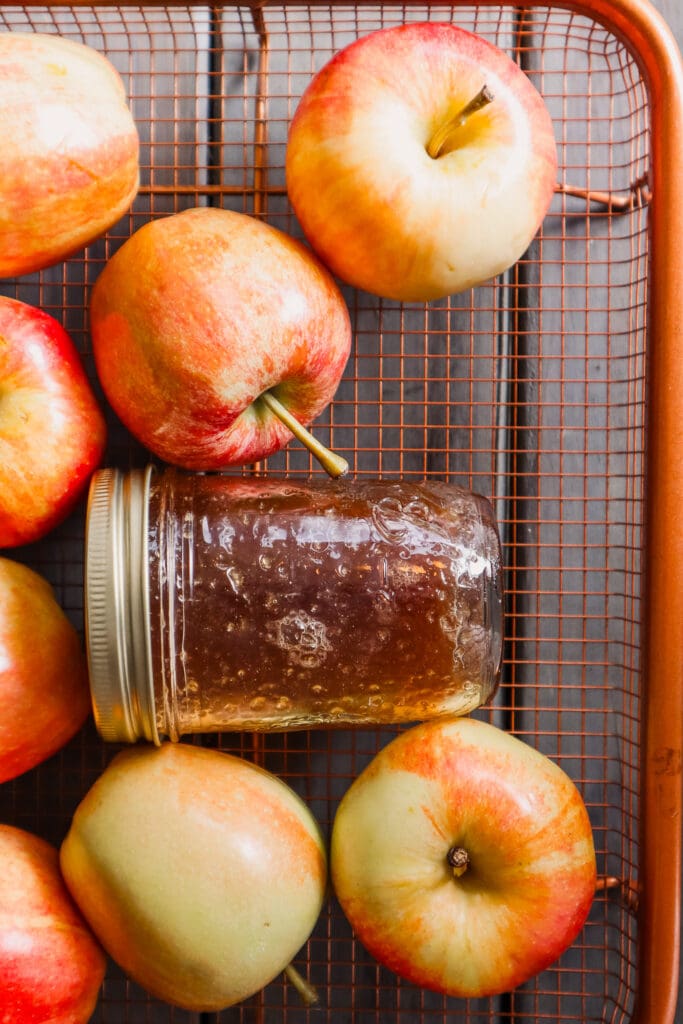 Apple crisp macchiato syrup in mason jar in basket with apples