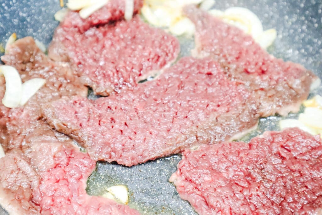 Venison cube steaks frying in skillet